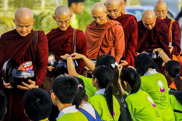 People offer alms to monks